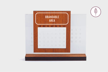 Wooden calendar with a clear base and a designated brandable area at the top